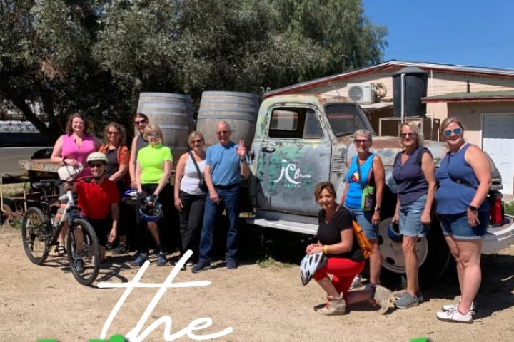 a group of people standing in front of a sign